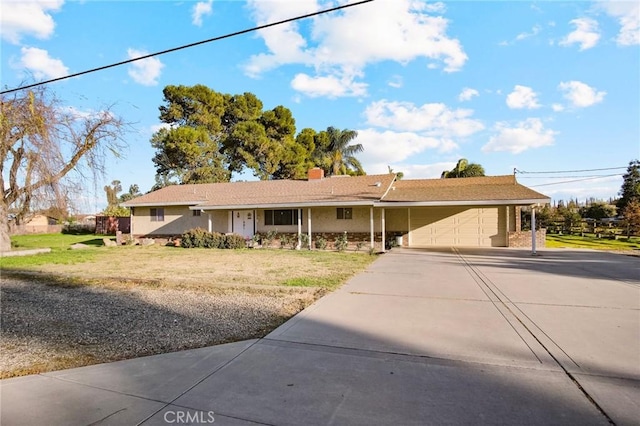 ranch-style home featuring a garage and a front lawn