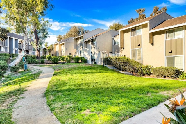 view of property's community with a yard