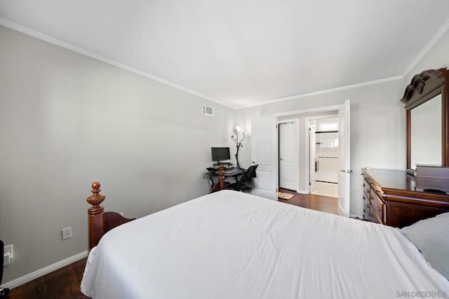 bedroom with crown molding, dark wood-type flooring, and ensuite bath