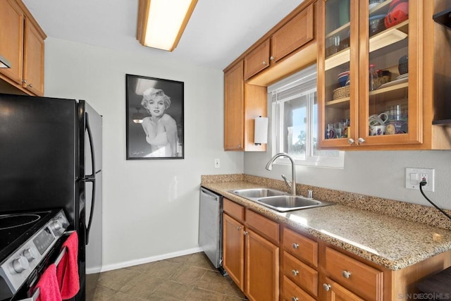 kitchen with range with electric stovetop, light stone countertops, sink, and stainless steel dishwasher