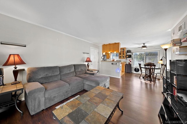 living room with ceiling fan, ornamental molding, dark hardwood / wood-style floors, and washer / clothes dryer