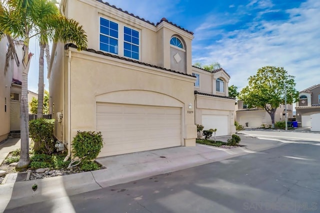 mediterranean / spanish house with a garage