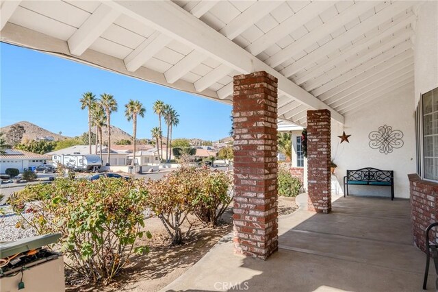 view of patio / terrace featuring a mountain view and covered porch