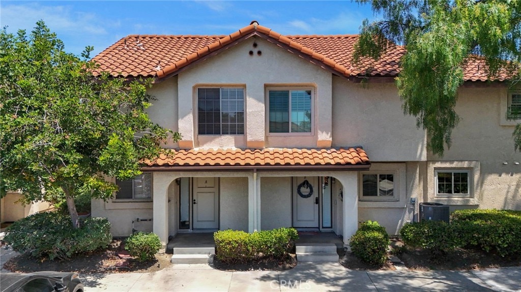 mediterranean / spanish-style home with cooling unit