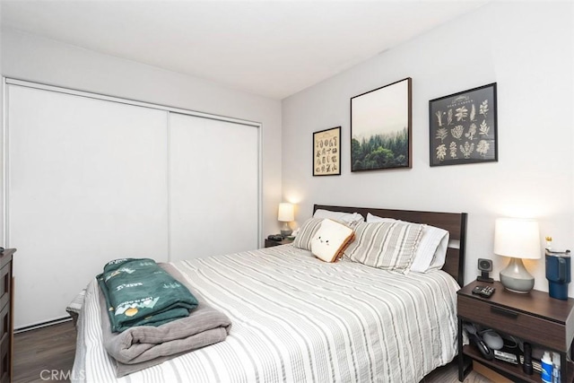 bedroom featuring a closet and dark hardwood / wood-style flooring