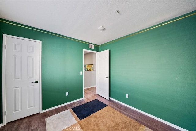 unfurnished bedroom with wood-type flooring