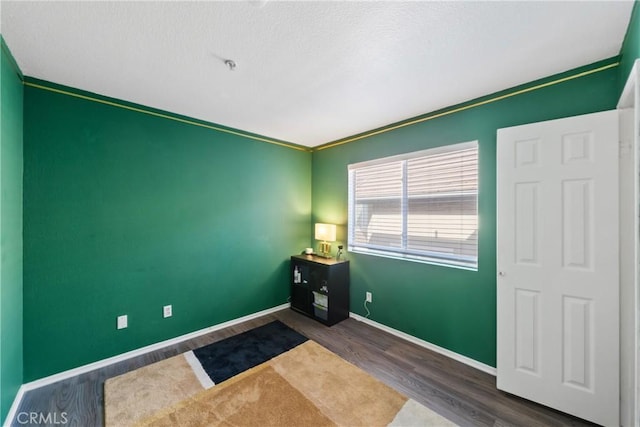 spare room featuring dark wood-type flooring