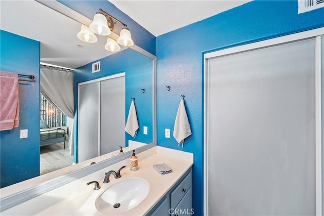 bathroom with a notable chandelier, vanity, and curtained shower