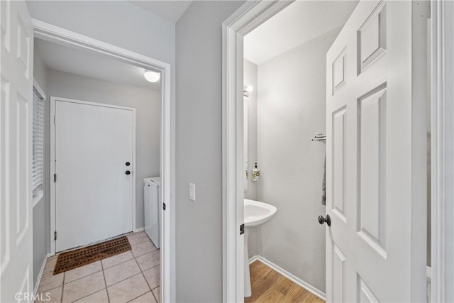 bathroom featuring washer and dryer and tile patterned floors