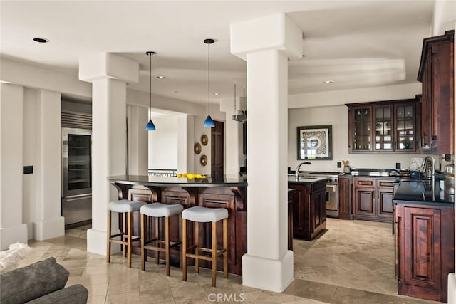 3252 Canyon Oaks, Chico, CA 95928 - kitchen featuring sink, dark brown cabinetry, and decorative light fixtures