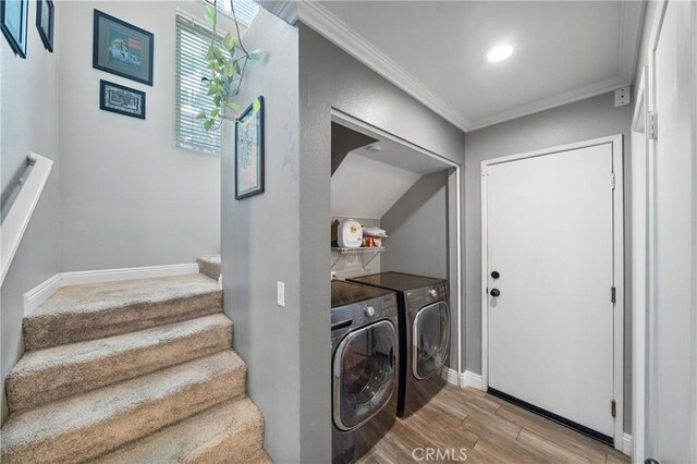 laundry area with ornamental molding and washer and clothes dryer