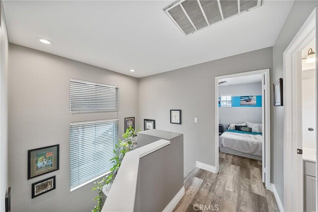 hallway with light hardwood / wood-style flooring