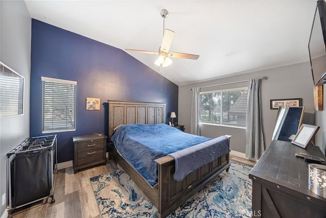 bedroom with light wood-type flooring, ceiling fan, and lofted ceiling