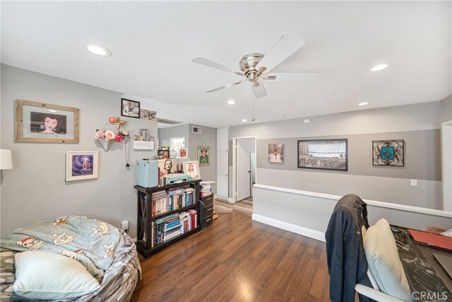 home office with ceiling fan and dark hardwood / wood-style flooring