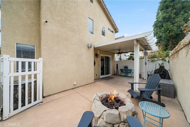 view of patio / terrace featuring ceiling fan and an outdoor fire pit