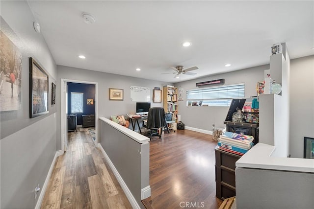 office area with dark wood-type flooring and ceiling fan