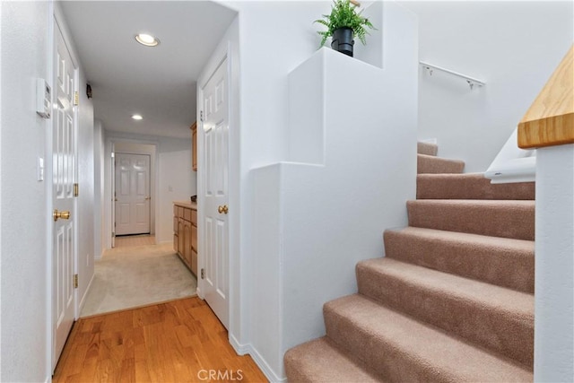 stairway with hardwood / wood-style flooring