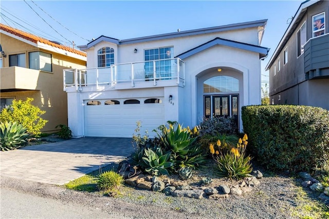 view of front of property with a garage and a balcony