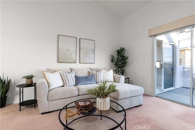 living room with vaulted ceiling and light carpet