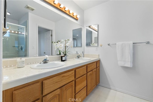 bathroom with vanity and a shower with shower door