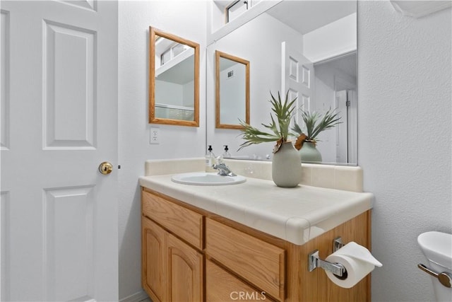 bathroom with vanity and toilet