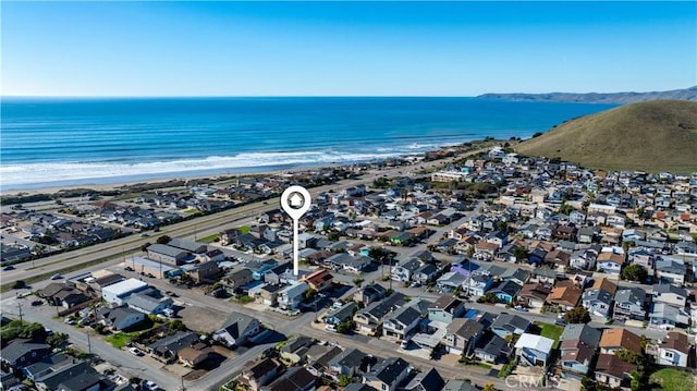 birds eye view of property featuring a view of the beach and a water view