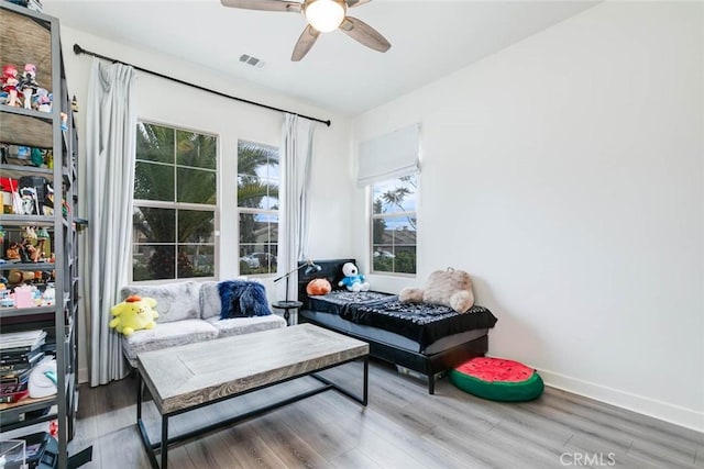 living room featuring hardwood / wood-style flooring and ceiling fan