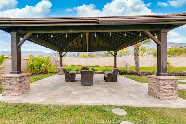 view of patio featuring a gazebo and a mountain view