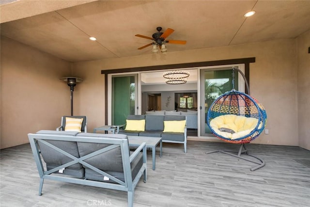 view of patio featuring ceiling fan, a deck, and an outdoor living space