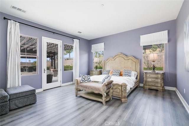 bedroom featuring access to exterior and light hardwood / wood-style floors