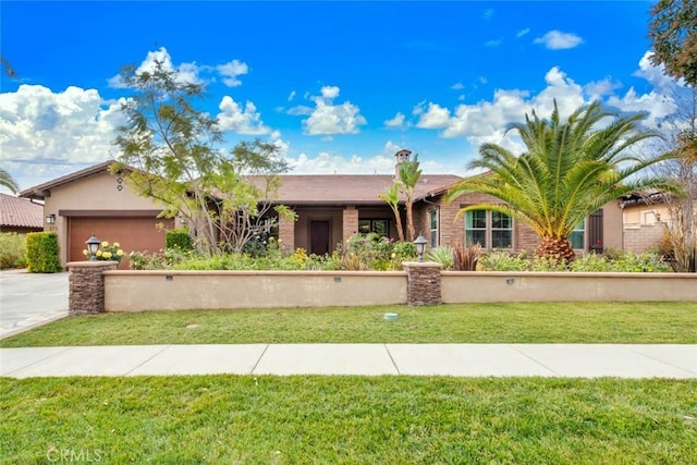 view of front of property featuring a garage and a front yard