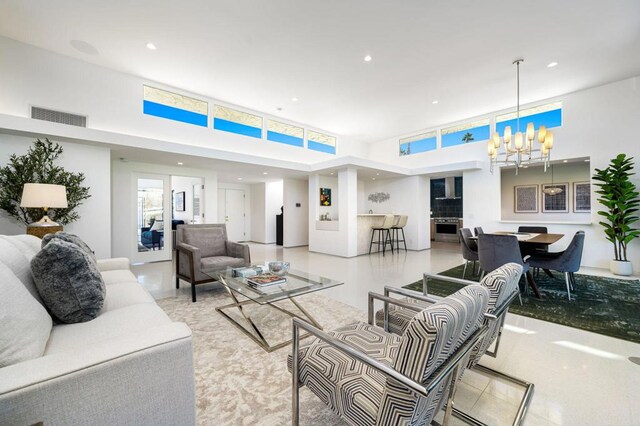 living room featuring a high ceiling and an inviting chandelier