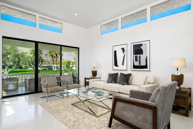 living room featuring a towering ceiling