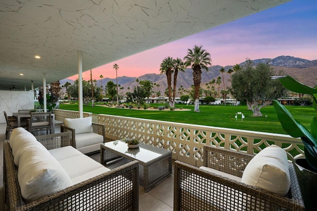 patio terrace at dusk featuring an outdoor hangout area and a mountain view