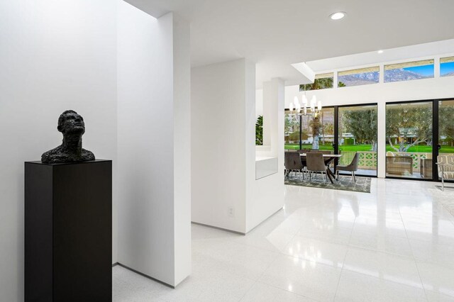 hallway featuring an inviting chandelier