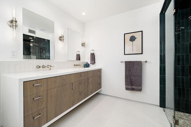 bathroom featuring an enclosed shower, vanity, decorative backsplash, and tile patterned flooring