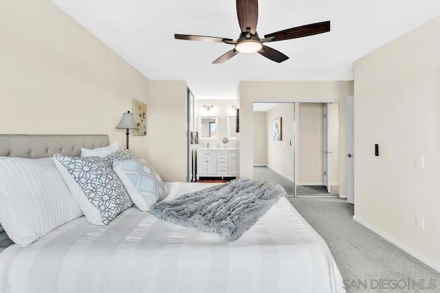 bedroom with ceiling fan, ensuite bath, a closet, and carpet