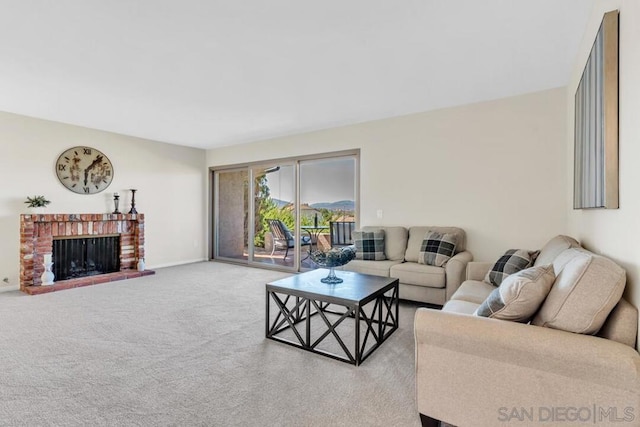 living room with light colored carpet and a fireplace