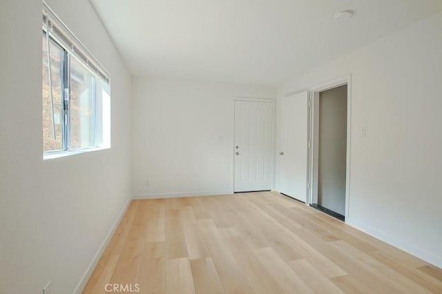 unfurnished room featuring light wood-type flooring