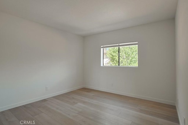 spare room with light hardwood / wood-style floors