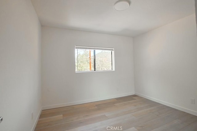 spare room featuring light wood-type flooring