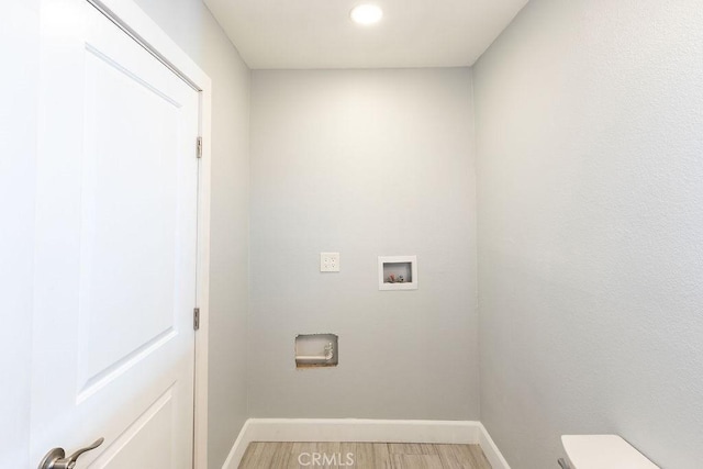 laundry area featuring washer hookup and hardwood / wood-style flooring