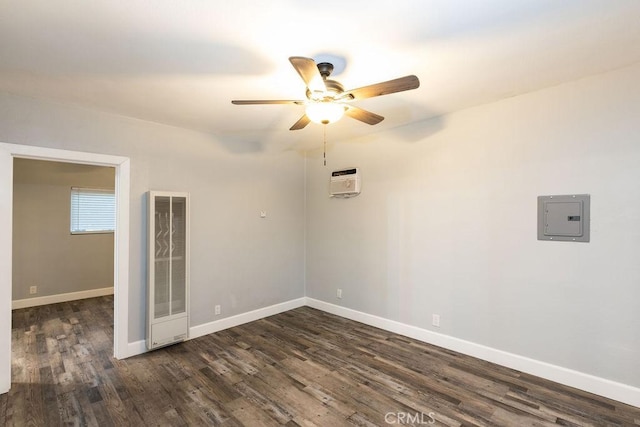 spare room featuring ceiling fan, dark hardwood / wood-style floors, and electric panel