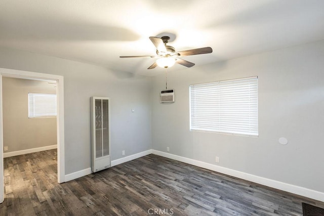 unfurnished room featuring ceiling fan, dark hardwood / wood-style flooring, and a wall mounted AC