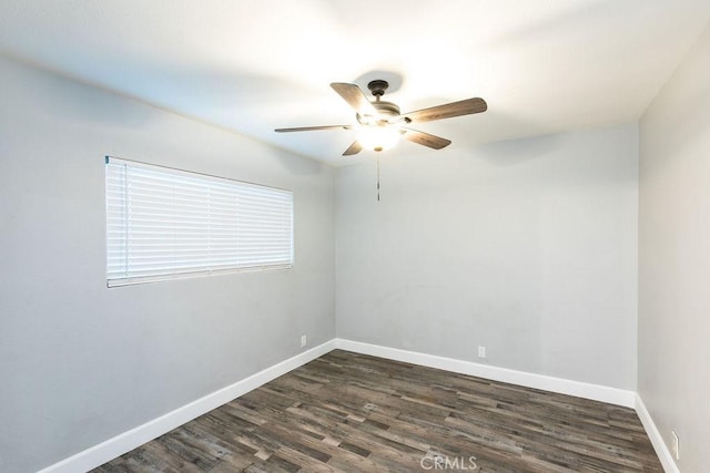 spare room with ceiling fan and dark hardwood / wood-style flooring