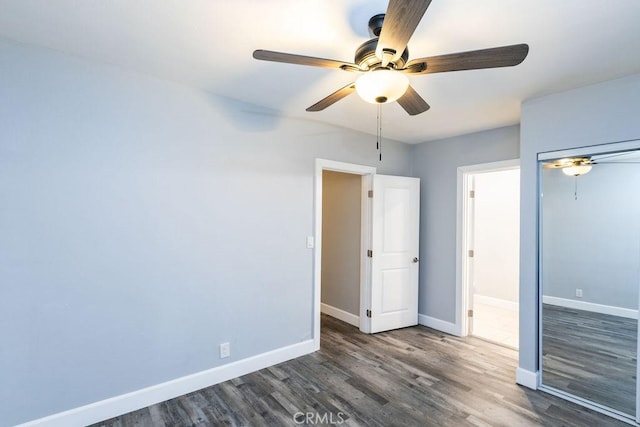 unfurnished bedroom with dark wood-type flooring and ceiling fan