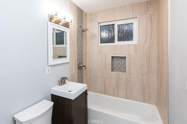 full bathroom with toilet, vanity, and tiled shower / bath combo