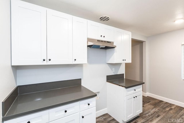 kitchen with dark hardwood / wood-style flooring and white cabinets