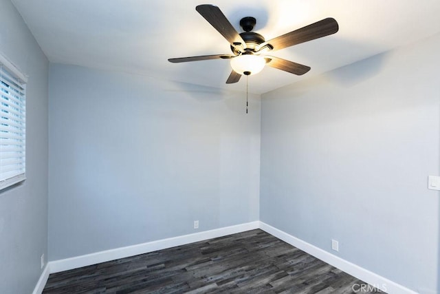 empty room with ceiling fan and dark hardwood / wood-style floors