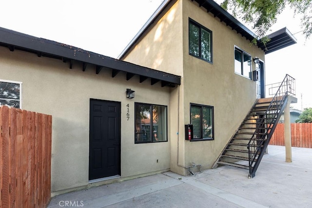 view of exterior entry featuring a patio area